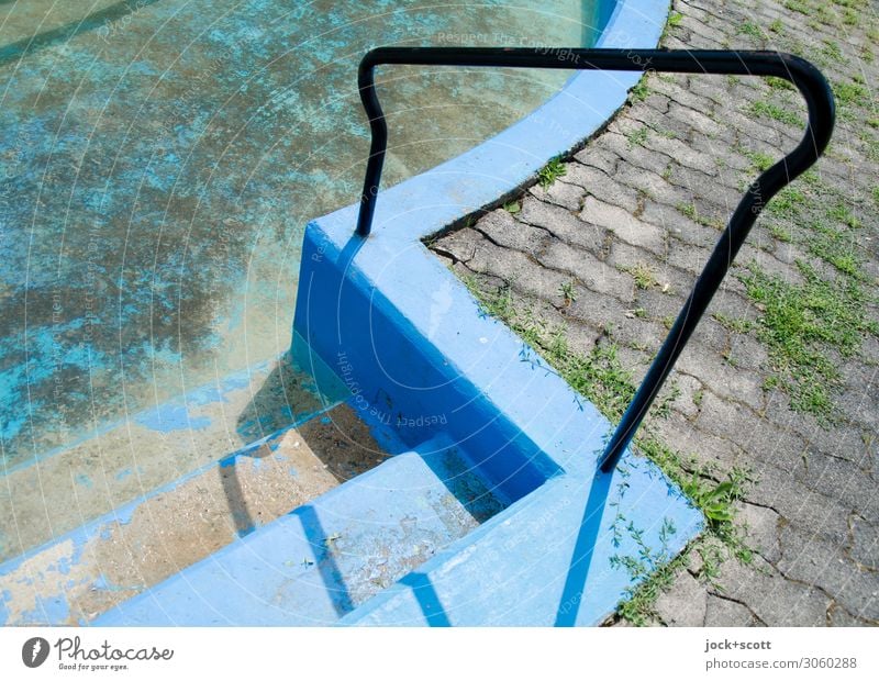 Handrail to the abandoned swimming pool lost places Neukölln Swimming pool Stairs Banister Paving stone Concrete Curved Dirty Sharp-edged Dry Under Blue