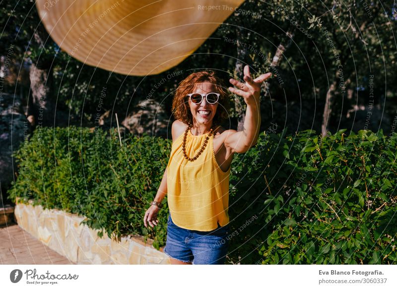 Beautiful girl at sunset holding a hat in her hand and throwing it to the camera. Summer, fun and lifestyle outdoors Freedom Human being Smiling