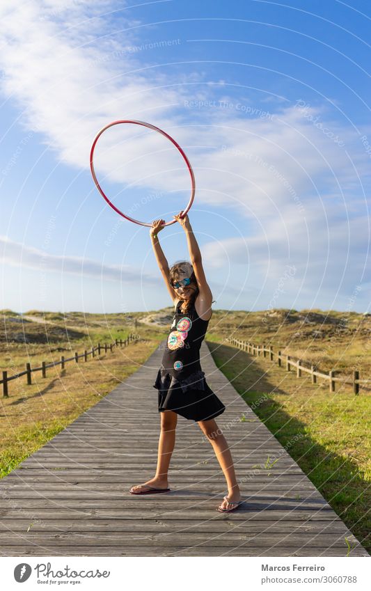 girl with hoop on the beach Lifestyle Beautiful Freedom Sun Beach Human being Feminine Child Girl Young woman Youth (Young adults) Woman Adults 1 0 - 12 months