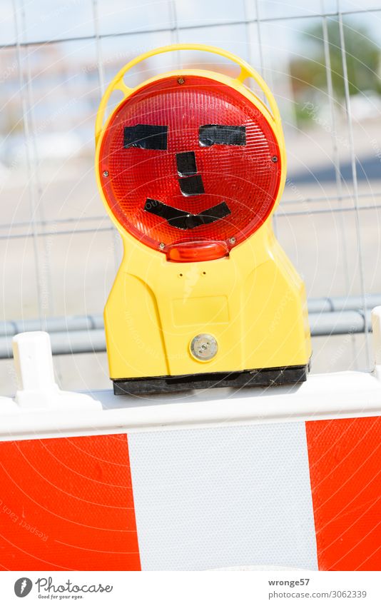 Joker III Traffic infrastructure Street Funny Yellow Red White Construction site Hoarding Warning light Protective Grating Joy Comical Funster Colour photo