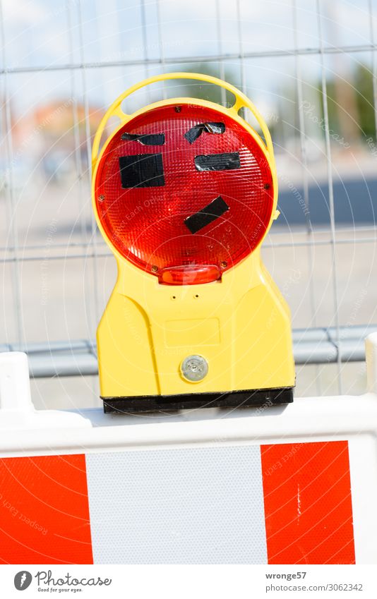Joker I Lamp Funny Near Yellow Red White Construction site Protective Grating Hoarding Warning light Comical Joy Funster Colour photo Multicoloured