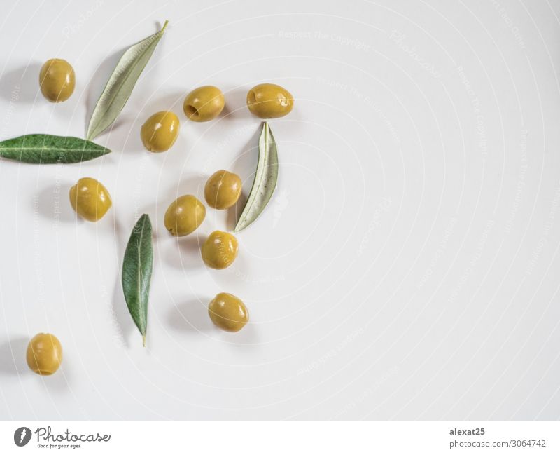 Pitted olives and leaves on white background with copy space Vegetable Fruit Vegetarian diet Beautiful Group Nature Plant Leaf Fresh Delicious Natural Green