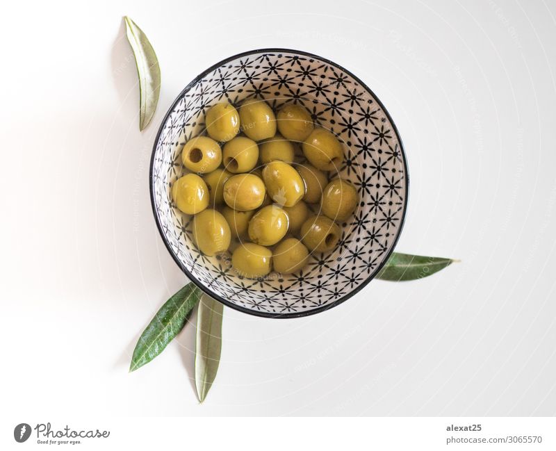 Pitted olives in a bowl on white background Vegetable Fruit Vegetarian diet Bowl Beautiful Group Nature Plant Leaf Fresh Delicious Natural Green White Berries