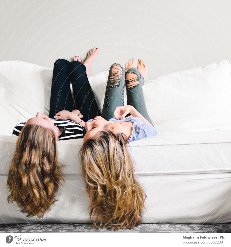 Besties Lifestyle Sofa Long-haired Hang Smiling Laughter Lie To talk Thin Friendliness Together Happy Beautiful Modern Positive Feminine Joy Happiness