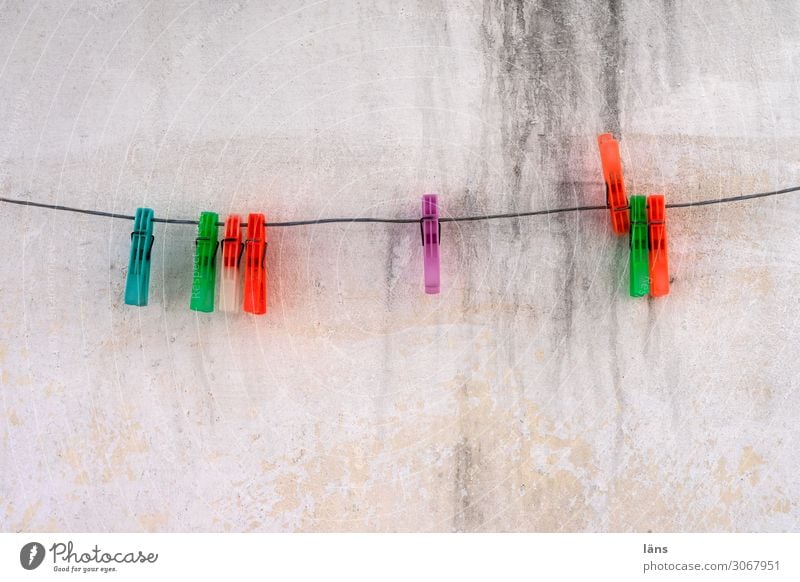 clothespins Living or residing Rope Island Paros Wall (barrier) Wall (building) Authentic Simple Cheap Sustainability Clothes peg Greece Colour photo