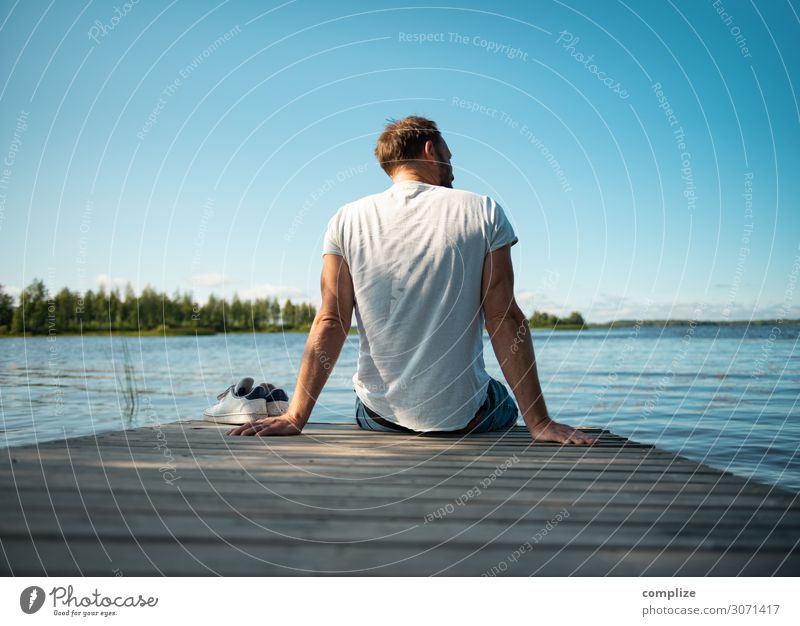 Man sitting on wooden walkway by the lake in Finland Happy Healthy Alternative medicine Wellness Harmonious Relaxation Calm Sauna Swimming & Bathing