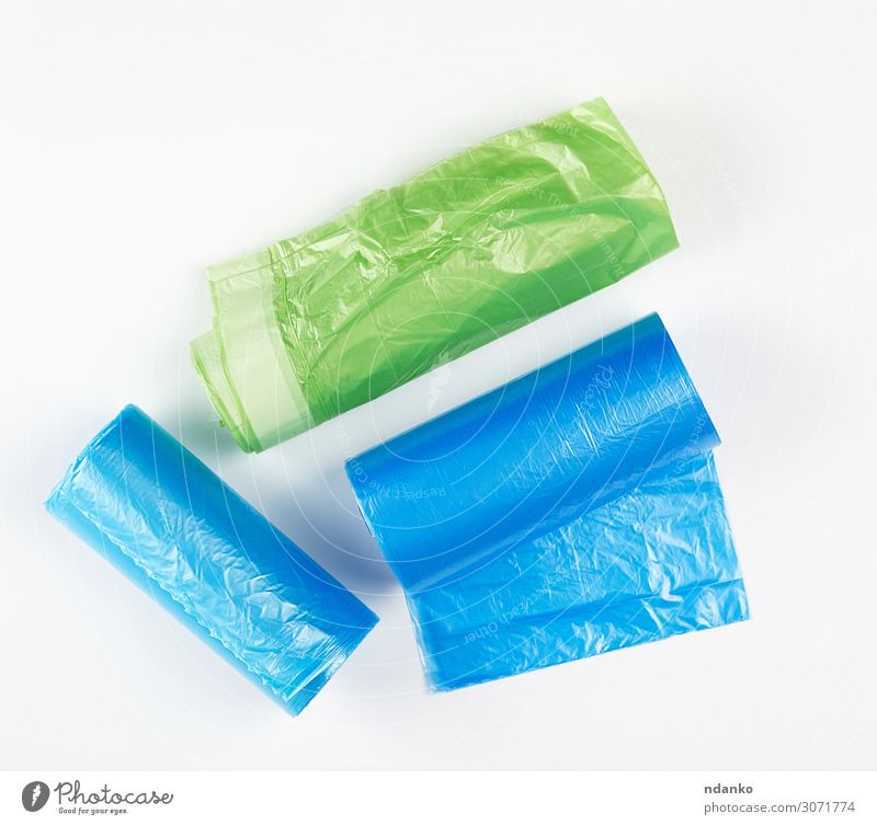 three rolled up rolls with plastic garbage bags Tool Environment Container Package Plastic New Clean Blue Green White Colour Environmental pollution bin