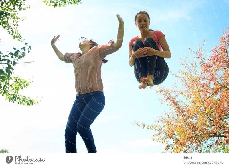 Two girls jump on the trampoline, in nature. Life Senses Leisure and hobbies Playing Vacation & Travel Summer Sports Fitness Sports Training Human being
