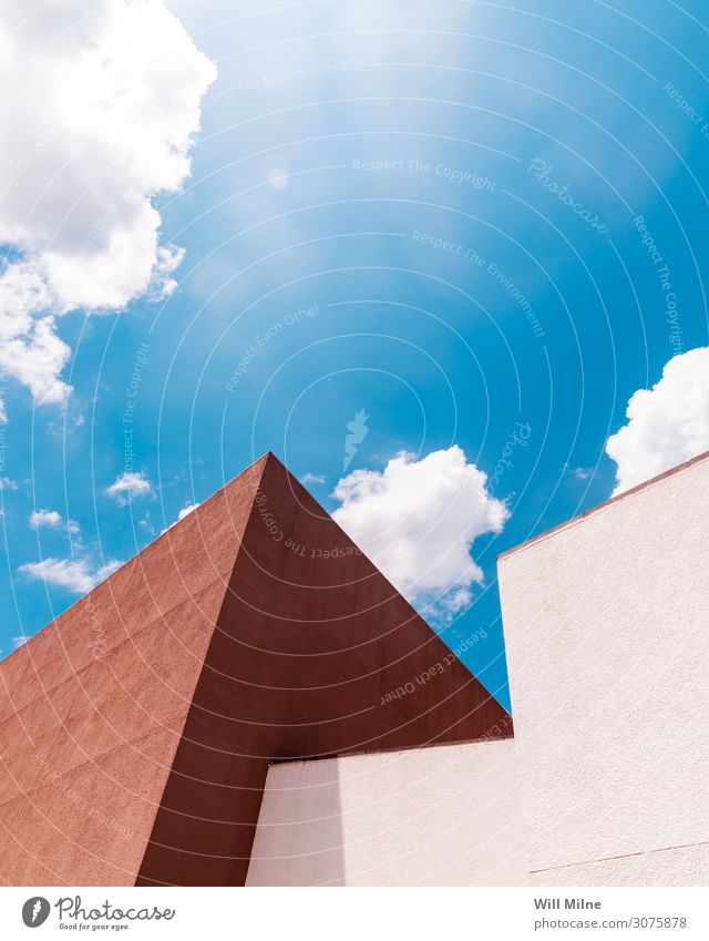 Modern Building in Front of a Cloudy Sky Structures and shapes Corner Architecture Blue Brown Clouds