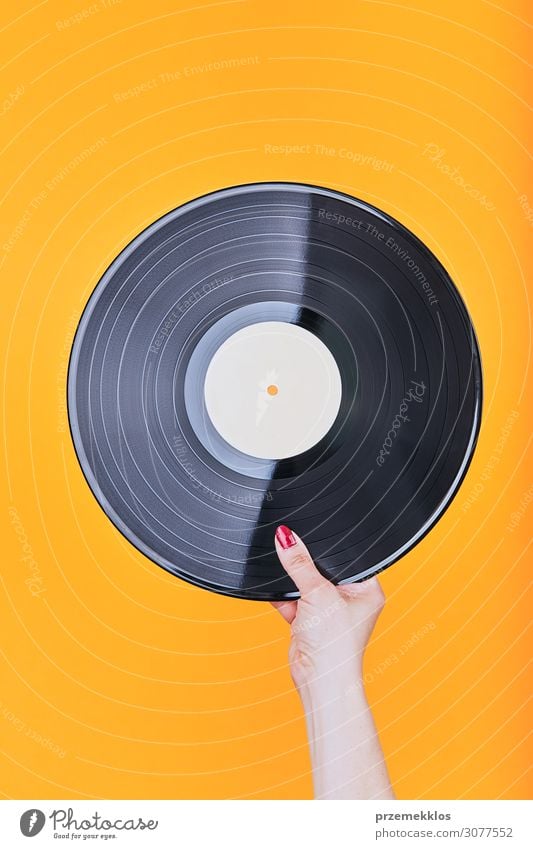 Vinyl record over a plain orange background Lifestyle Style Playing Entertainment Music Technology Listen to music Record Media Collection Feasts & Celebrations