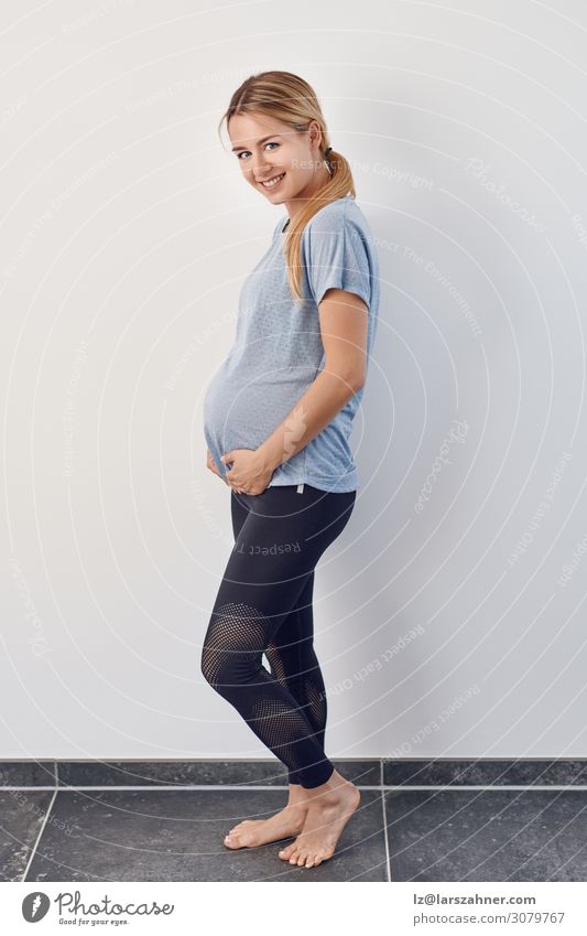 Side view of happy casual barefoot pregnant woman Happy Body Baby Woman Adults 1 Human being 18 - 30 years Youth (Young adults) Warmth Blonde Think Fitness