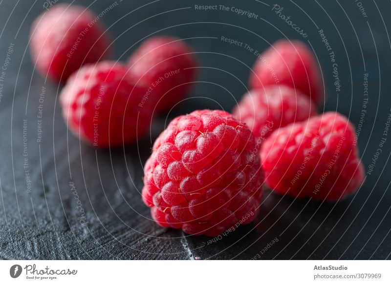 Raspberries on black cement background, closeup and space for text dry natural nature sweet abstract table red summer delicious macro backdrop ripe fruits
