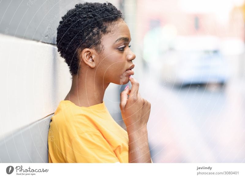 Thoughtful black woman with sad expression on urban wall Lifestyle Style Beautiful Hair and hairstyles Face Human being Feminine Young woman