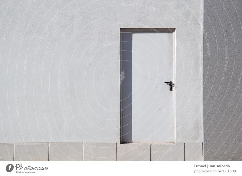 white door on the white wall of the building in the city Door Wall (building) White Building Facade Surface Structures and shapes Exterior shot Architecture