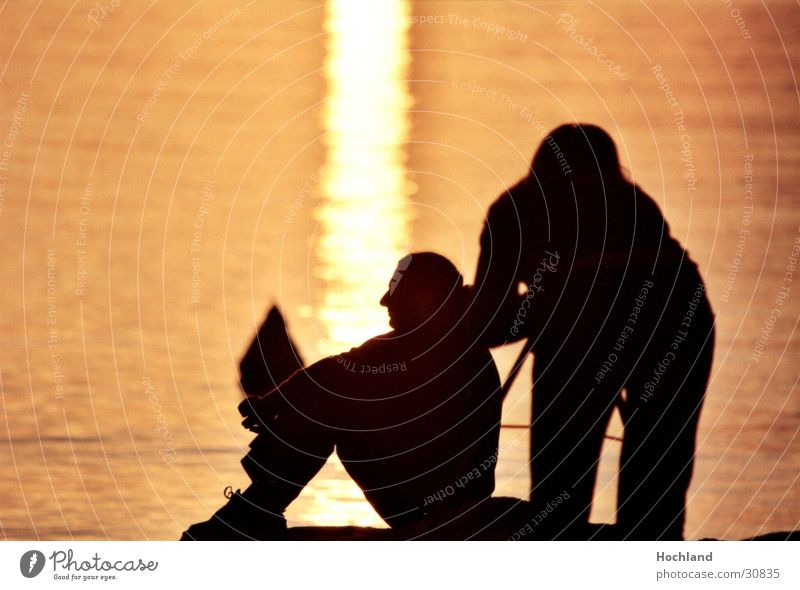 Shoelaces in the evening Sunset Photographer Dusk Man Woman Back-light Water Couple Sit