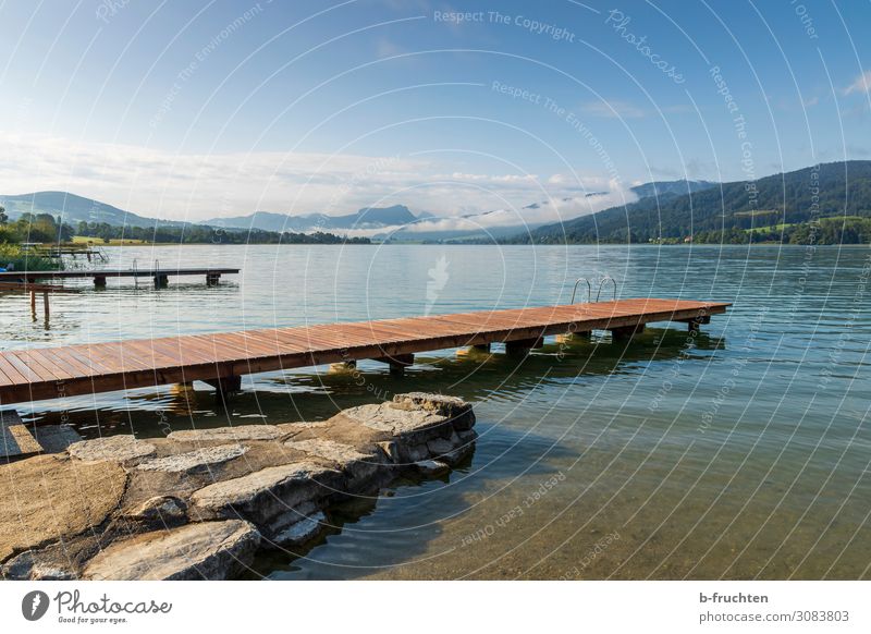 Lake with wooden footbridges Harmonious Contentment Relaxation Calm Nature Landscape Clouds Horizon Summer Autumn Beautiful weather Alps Mountain Lakeside Free