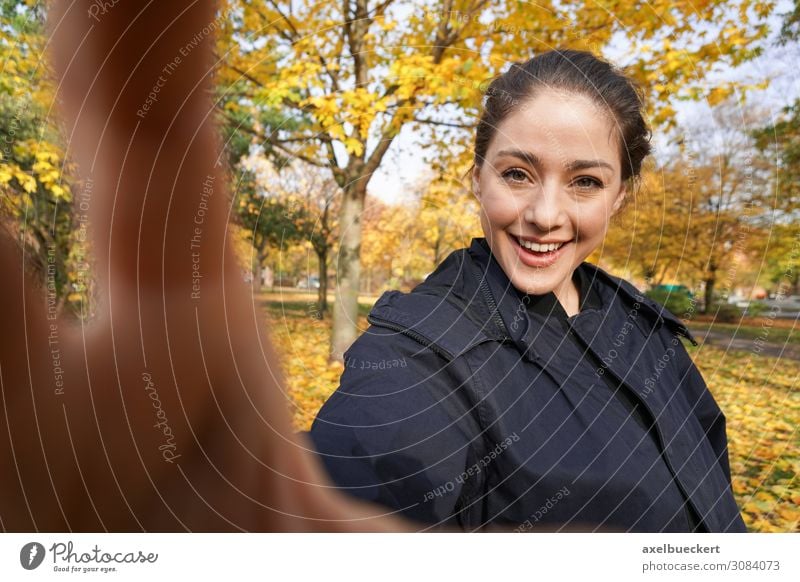 happy young woman making selfie in the fall. Selfie Funny Lifestyle Take a photo by hand real people Joy Leisure and hobbies Camera Young woman Woman Adults