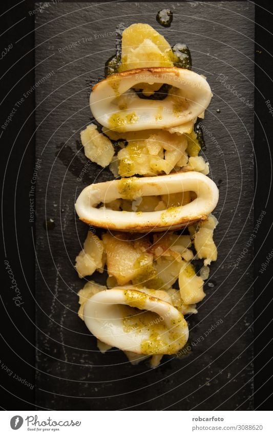Spanish squid top with potatoes Seafood Lunch Dinner Plate Table Restaurant Wood Fresh Delicious Red Tradition Squid appetizer background Meal Cooking spanish