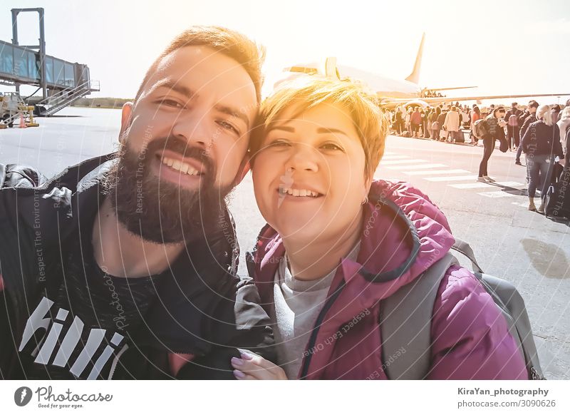 Smiling millennial couple taking selfie during airport departures Lifestyle Happy Beautiful Face Vacation & Travel Tourism Trip Adventure Summer Woman Adults