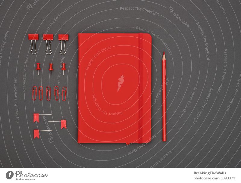 Neatly organized red stationery flat lay on grey Desk Table Workplace Office Stationery Paper Dark Modern Above Gray Red Black Colour Creativity Supply