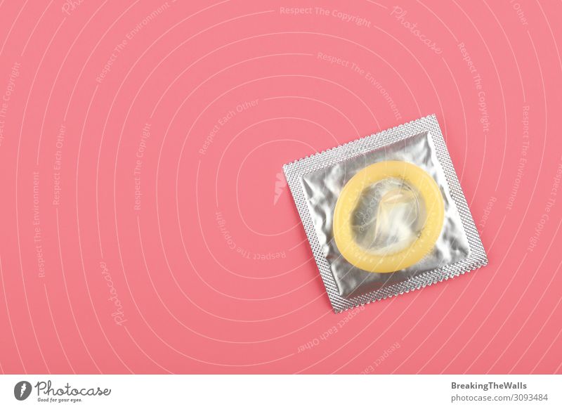 Close up one condom pack over pink background Personal hygiene Healthy Health care Medication Above Clean Pink Protection Responsibility Caution Threat