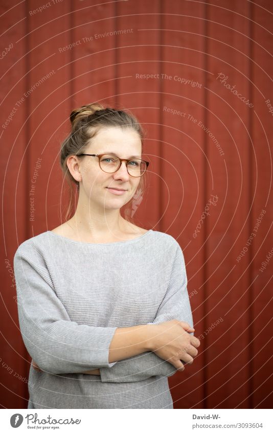 Young natural blonde woman smiles Woman Young woman smiled smilingly Blonde Friendliness Eyeglasses Wearer of glasses kind Positive red background
