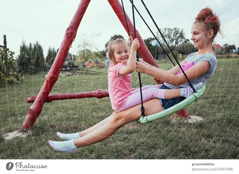 Sisters having fun on a swing together Joy Vacation & Travel Summer Summer vacation Garden Child Family & Relations 2 Human being 3 - 8 years Infancy