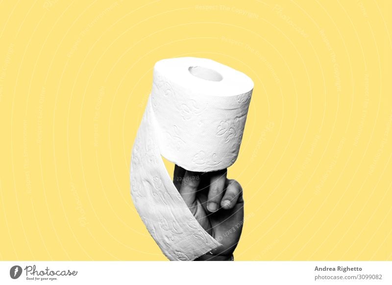 Concept of constipation, diarrhea, problem. Hand holding a toilet paper roll. The subject is black and white. The background is yellow. Copy space