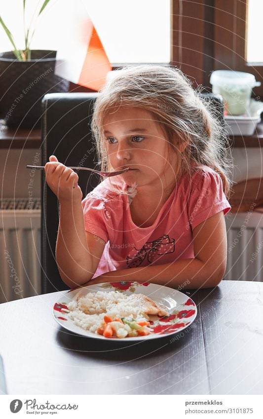 Child having a dinner at home Vegetable Eating Lunch Dinner Plate Cutlery Fork Table Girl 1 Human being 3 - 8 years Infancy Authentic Fresh Small food Meal fish