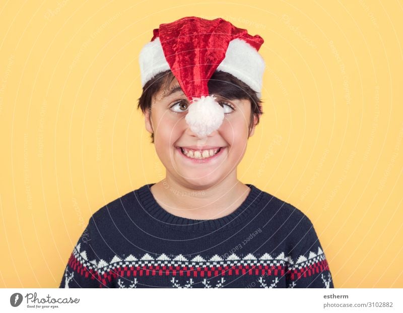 funny Child Wearing Christmas Santa Claus Hat on yellow background Joy Winter Feasts & Celebrations Christmas & Advent New Year's Eve Human being Masculine