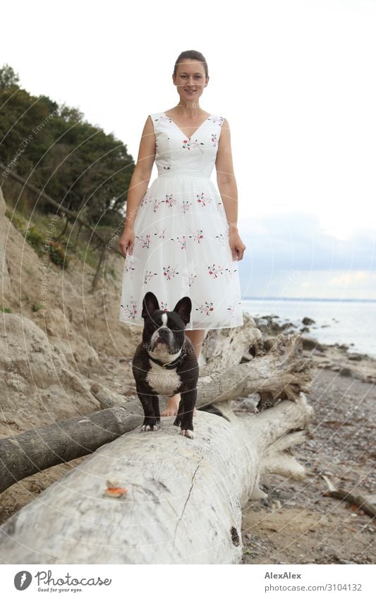 Young woman and French bulldog on tree trunk at the beach Elegant Style Joy already Harmonious Beach Ocean Youth (Young adults) 18 - 30 years Adults