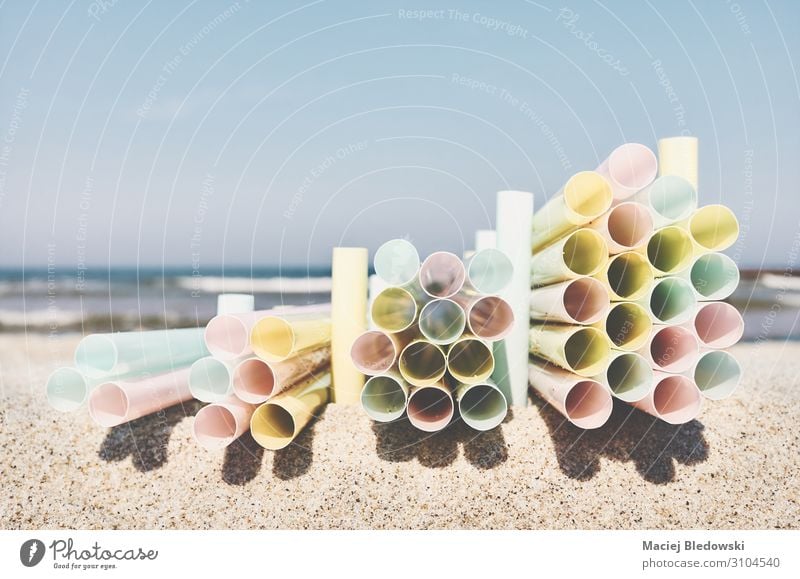 Stacks of plastic straws on a beach. Beach Ocean Industry Environment Nature Sand Sky Tube Plastic Tourism Environmental pollution Environmental protection