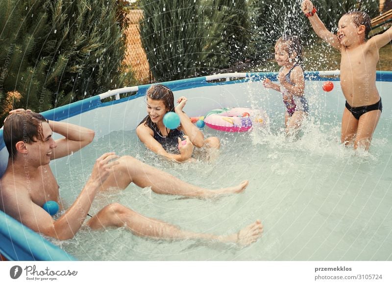 Children splashing in a pool Lifestyle Joy Happy Relaxation Swimming pool Playing Vacation & Travel Summer Garden Human being Girl Boy (child)