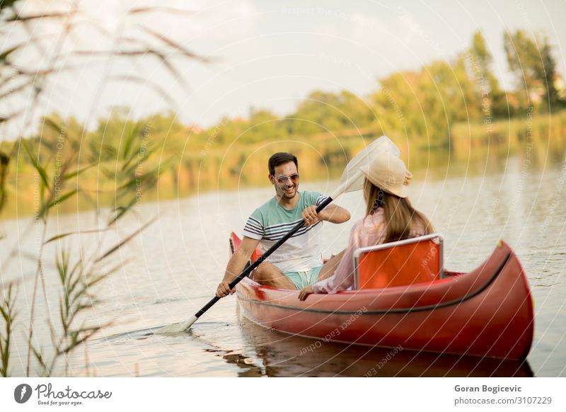 Loving couple rowing on the lake Lifestyle Joy Happy Relaxation Leisure and hobbies Vacation & Travel Tourism Summer Sports Human being Woman Adults Man Couple