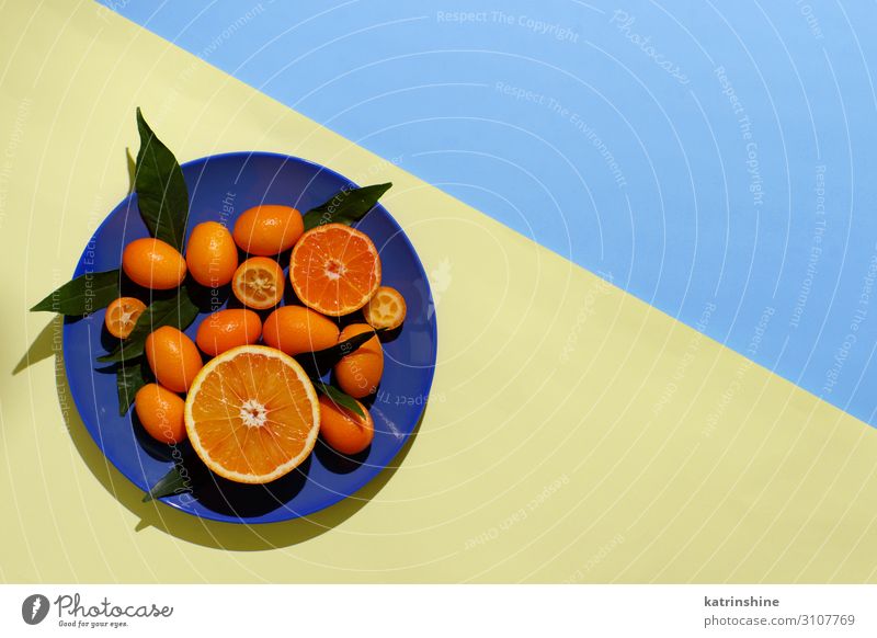Citrus fruits on a yellow and blue background Fruit Nutrition Vegetarian diet Diet Plate Exotic Summer Group Leaf Fresh Modern Natural Juicy Blue Yellow Colour