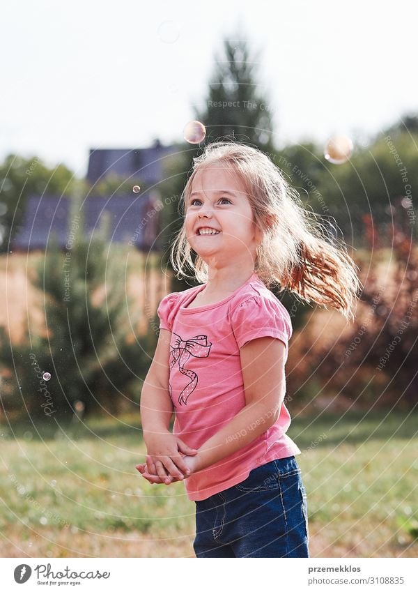 Little gir playing with soap bubbles Lifestyle Joy Happy Playing Garden Child Girl Infancy 1 Human being 30 - 45 years Adults Playground Authentic Happiness