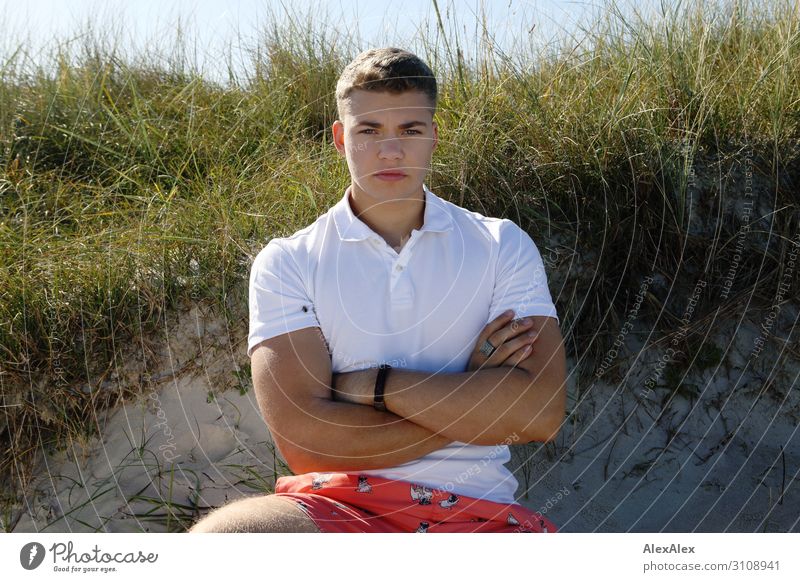 Backlit portrait of a young man in front of a beach dune Lifestyle already Athletic Summer Summer vacation Young man Youth (Young adults) 13 - 18 years