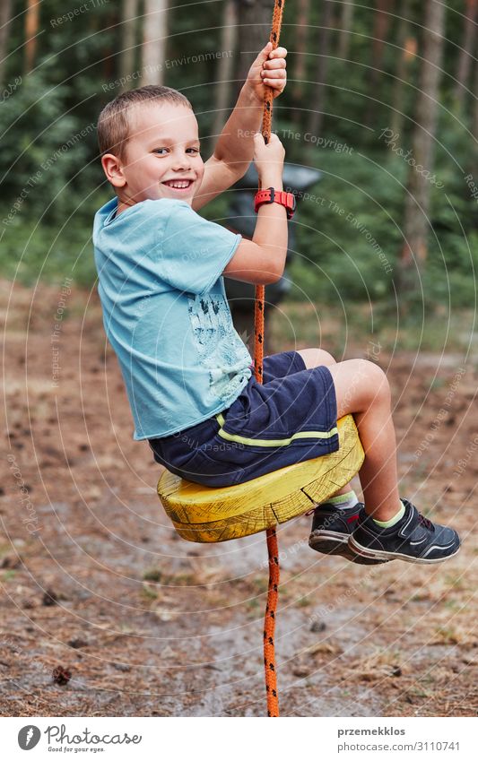 Happy boy riding on the zip line in rope park Joy Playing Vacation & Travel Adventure Summer Child Rope Human being Boy (child) Man Adults 1 3 - 8 years Infancy