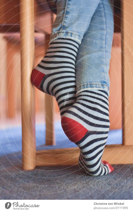 Warm striped socks and jeans on slim crossed legs Striped socks Youth (Young adults) Legs Jeans Authentic Happiness Cuddly Hip & trendy Feminine Cool (slang)