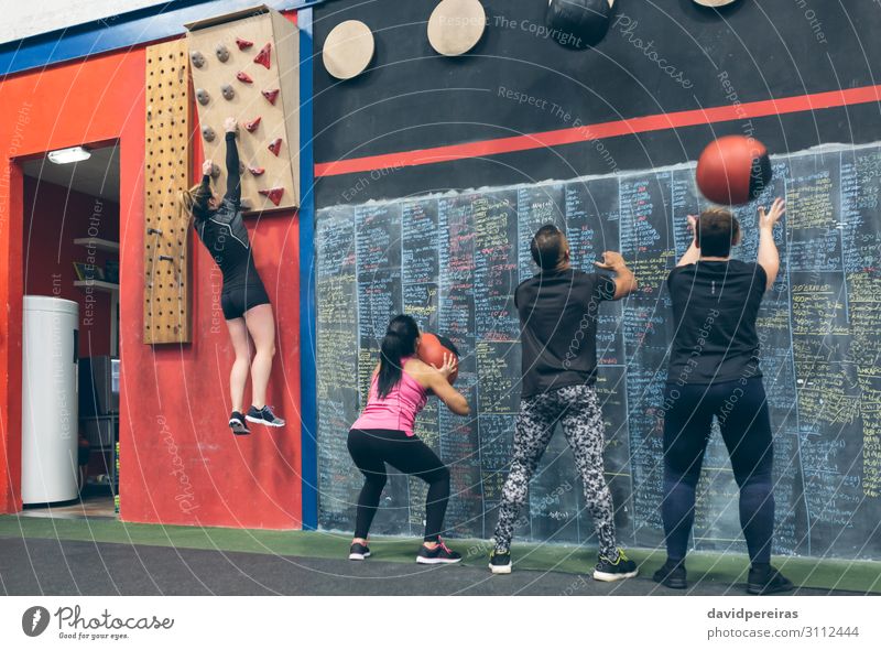 Group training at the box Lifestyle Sports Blackboard Human being Woman Adults Man Fitness Athletic Authentic Strong Effort wall ball Climbing wall cross fit