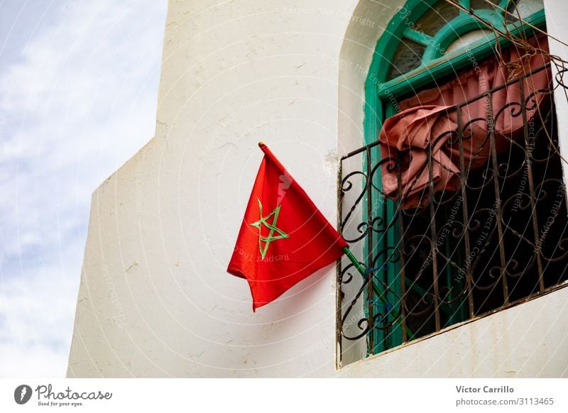 A moroccan flag in a window in the old town of Arsilah Morocco Africa Elegant Exotic Uniqueness Beautiful White Colour photo Day