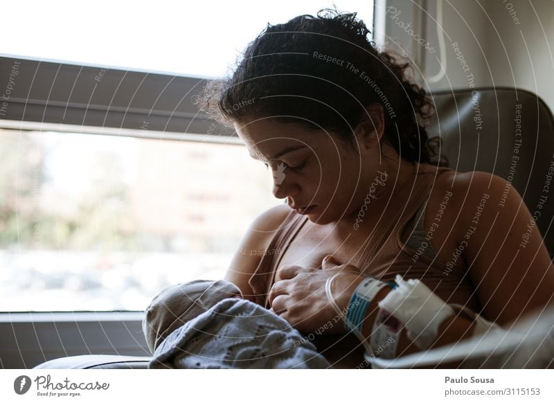 Mother breastfeeding baby at maternity Lifestyle Feminine Child Baby Adults 2 Human being 0 - 12 months 18 - 30 years Youth (Young adults) Eating To feed