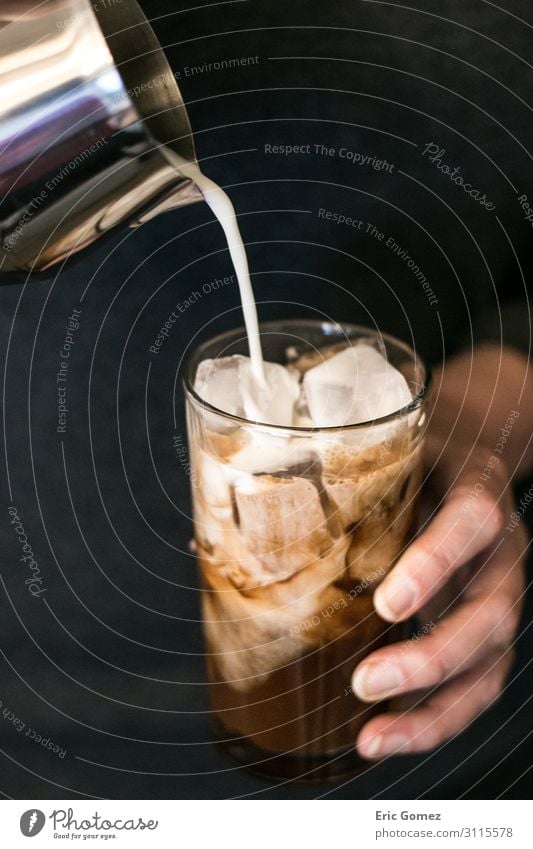 Woman pouring milk into iced chocolate espresso To have a coffee Beverage Cold drink Coffee Espresso Lifestyle Joy Human being Feminine Fingers 1 To enjoy