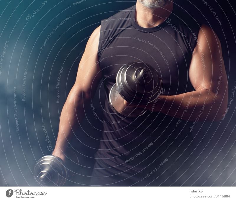 man in black clothes holds steel dumbbells Lifestyle Athletic Fitness Sports Sportsperson Man Adults Hand 1 Human being 30 - 45 years Steel Stand Muscular