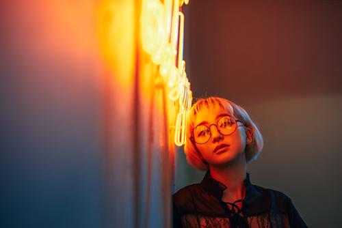 Young adult asian female wearing glasses in front of neon light sign, shallow selective focus Asians Blonde Eyeglasses Woman Young woman Girl Lighting