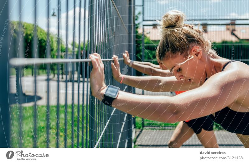Two young sportswomen resting on fence Roll Lifestyle Beautiful Personal hygiene Sports Human being Woman Adults Friendship Brunette Blonde Fitness Athletic