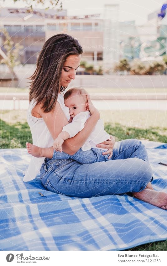 young mother breast feeding her baby girl outdoors in a park Eating Lifestyle Joy Beautiful Summer Sun Parenting Child Feminine Baby Young woman