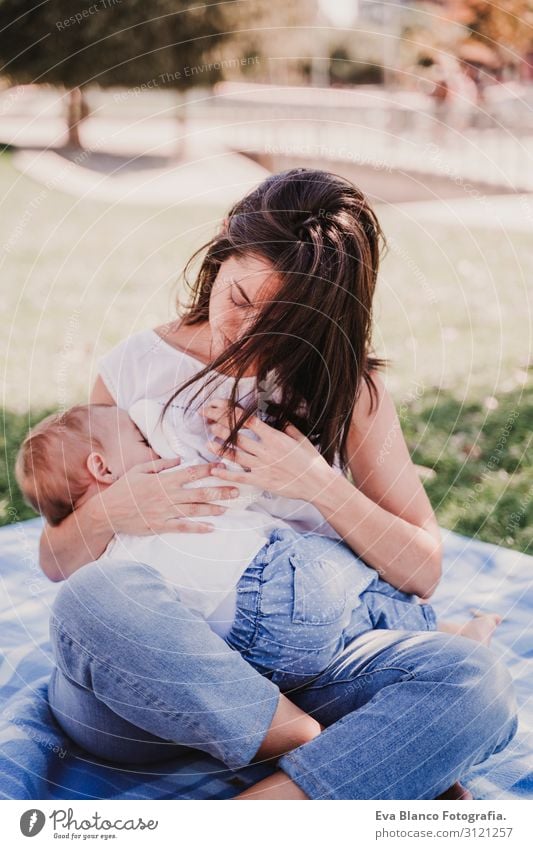 young mother breast feeding her baby girl outdoors in a park Eating Lifestyle Joy Beautiful Summer Sun Parenting Child Human being Feminine Baby Young woman