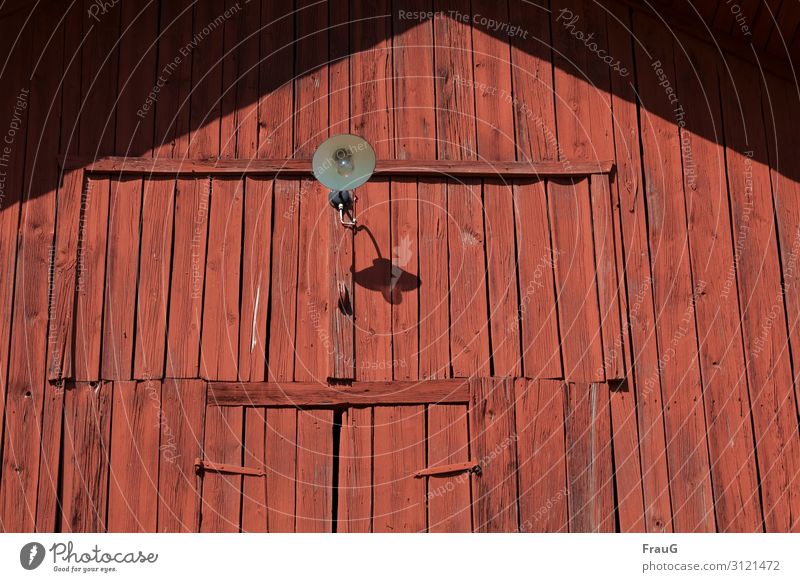 barn wall painted red Wall (building) Wood Texture of wood boards Nailed Canceled Red Swedish red Old Weathered door Locking bar Lamp Shadow Light Sunlight
