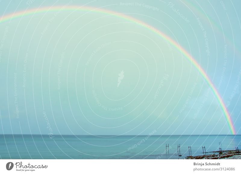 Beautiful shining rainbow over the sea Environment Nature Elements Air Sky Clouds Horizon Rainbow Illuminate Far-off places Gigantic Maritime Multicoloured